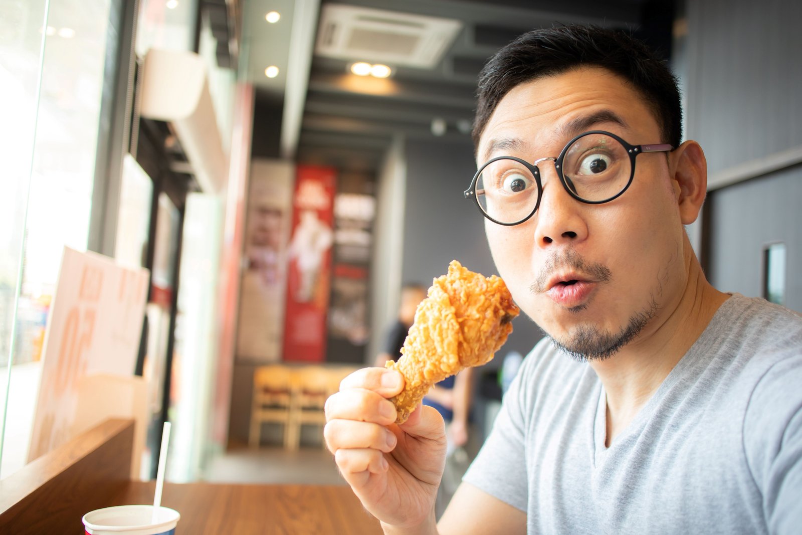 Husband enjoying fried chicken with crispy texture and rich flavour.