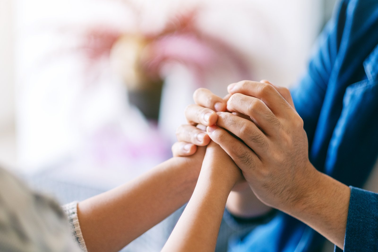 The husband and wife, holding hands, silently communicated their unwavering support for each other.