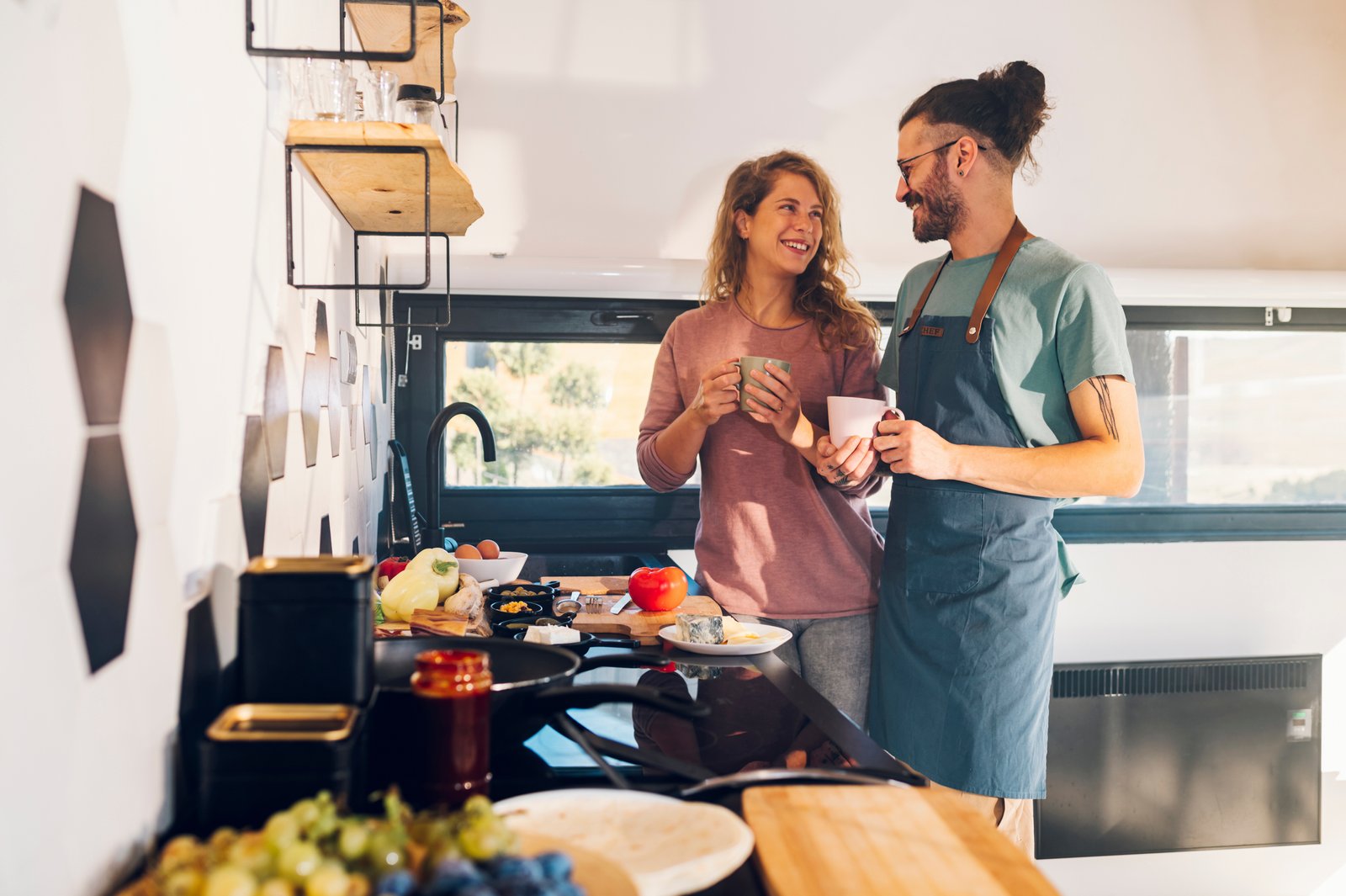 husband preparing coffee for wife