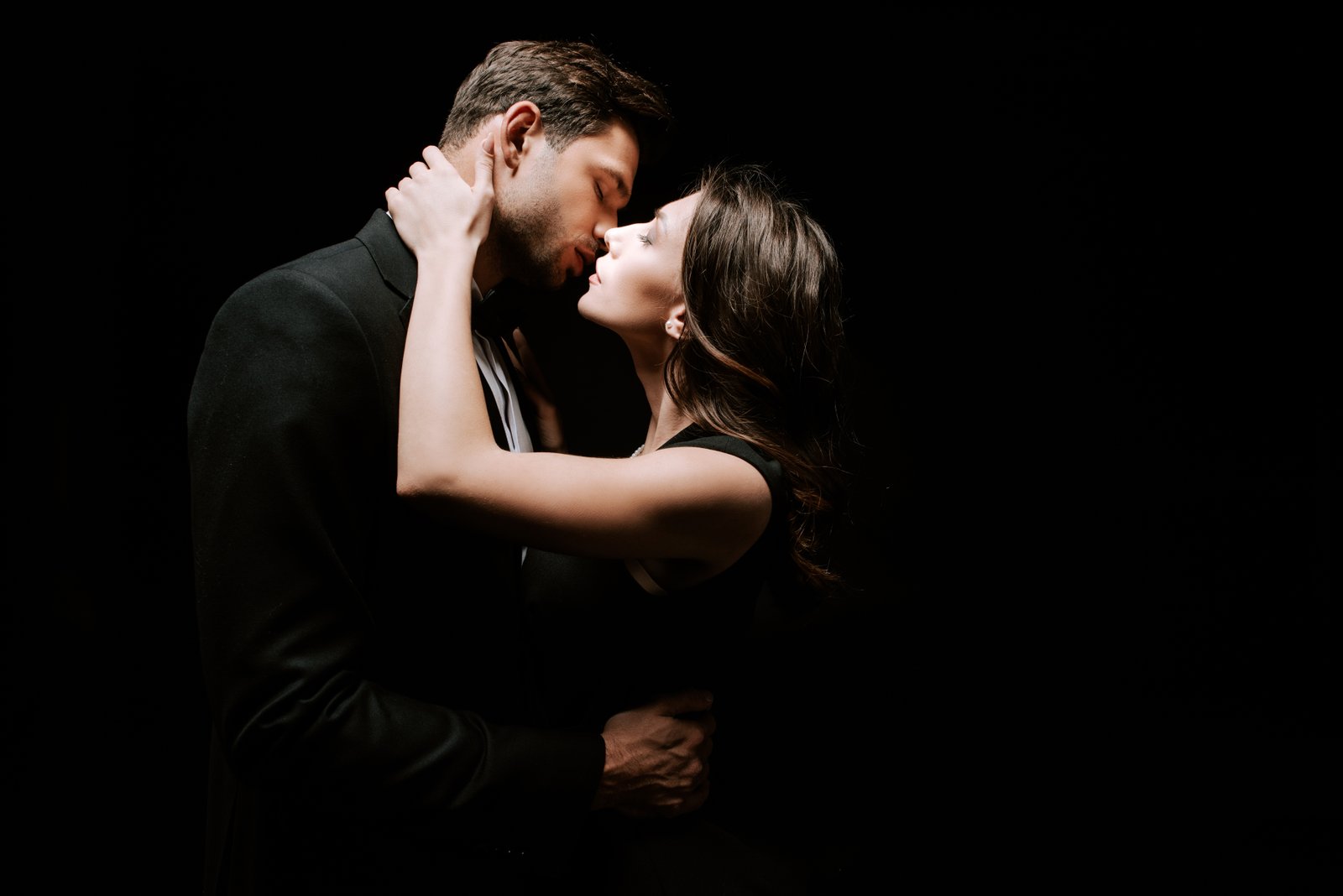man kissing woman 